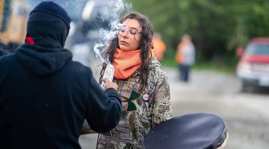 One of the protesters goes through a First nations cleansing ceremony
