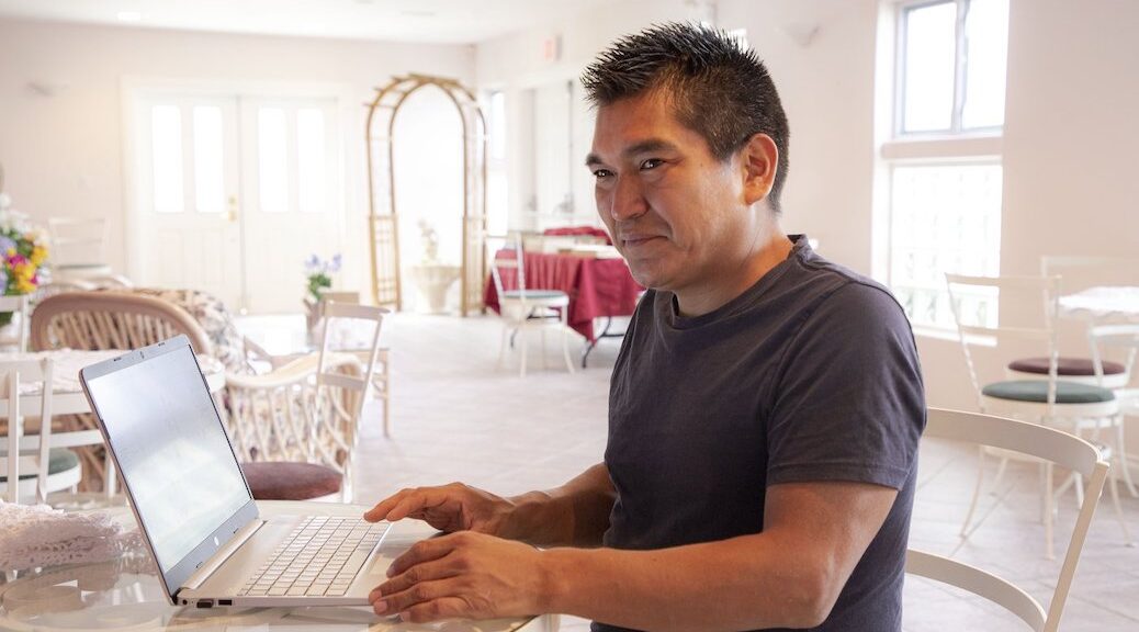 Indigenous man in front of computer