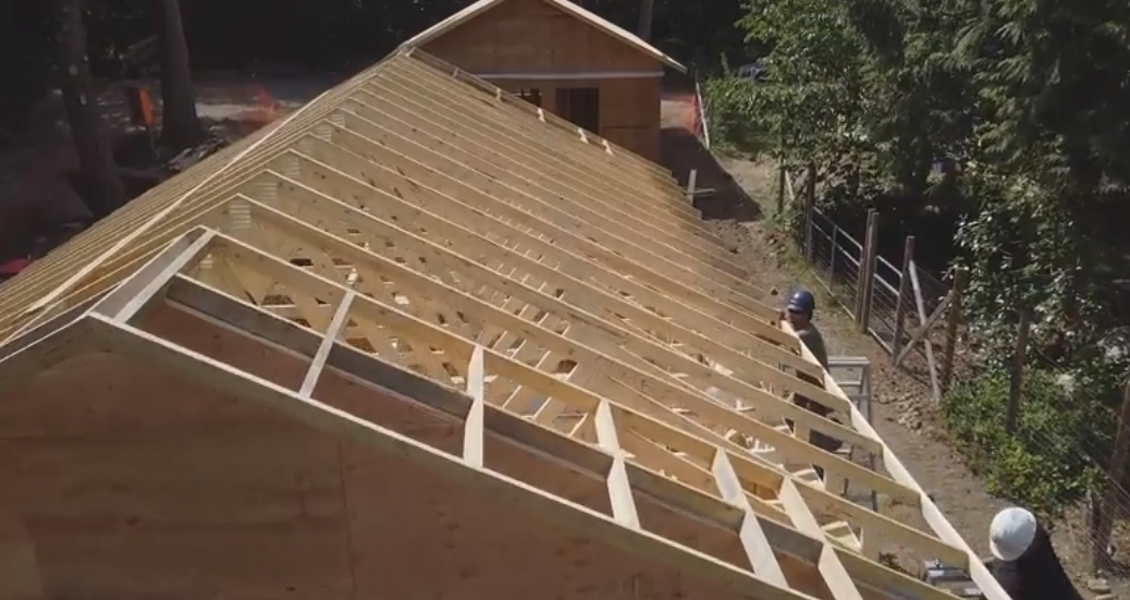 Carpenters working on a roof on
