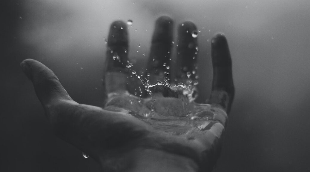 An open hand catching raindrops