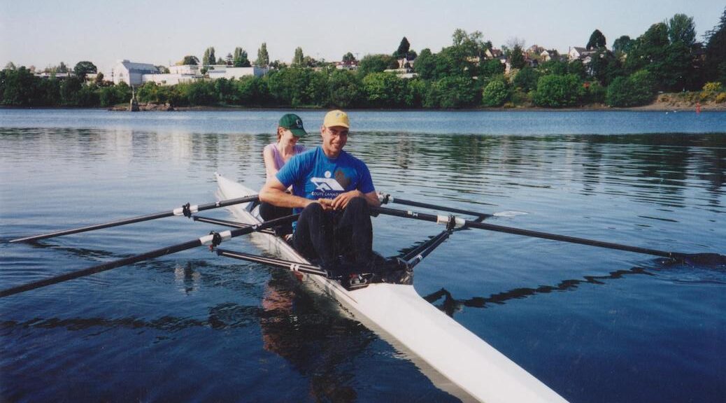A man and a woman rowing
