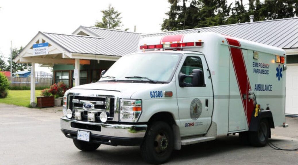 An ambulance sits in a parking lot