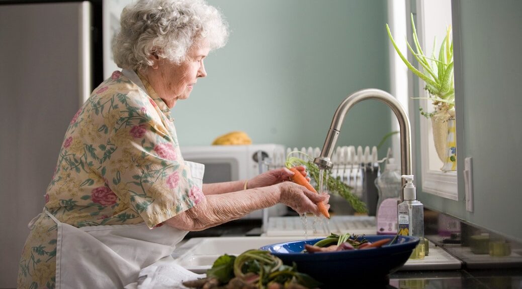 Elderly woman preparing supper