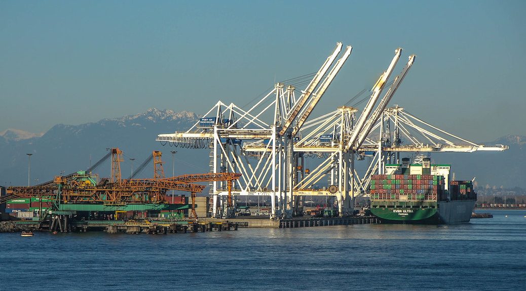 A container ship beside several large cranes