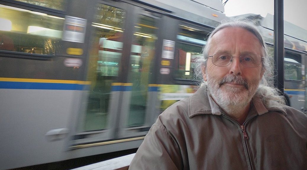 Man standing beside a moving train