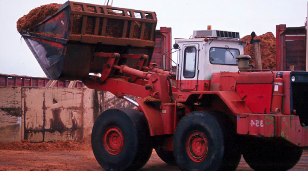 A 1989 front end loader with its bucket raised