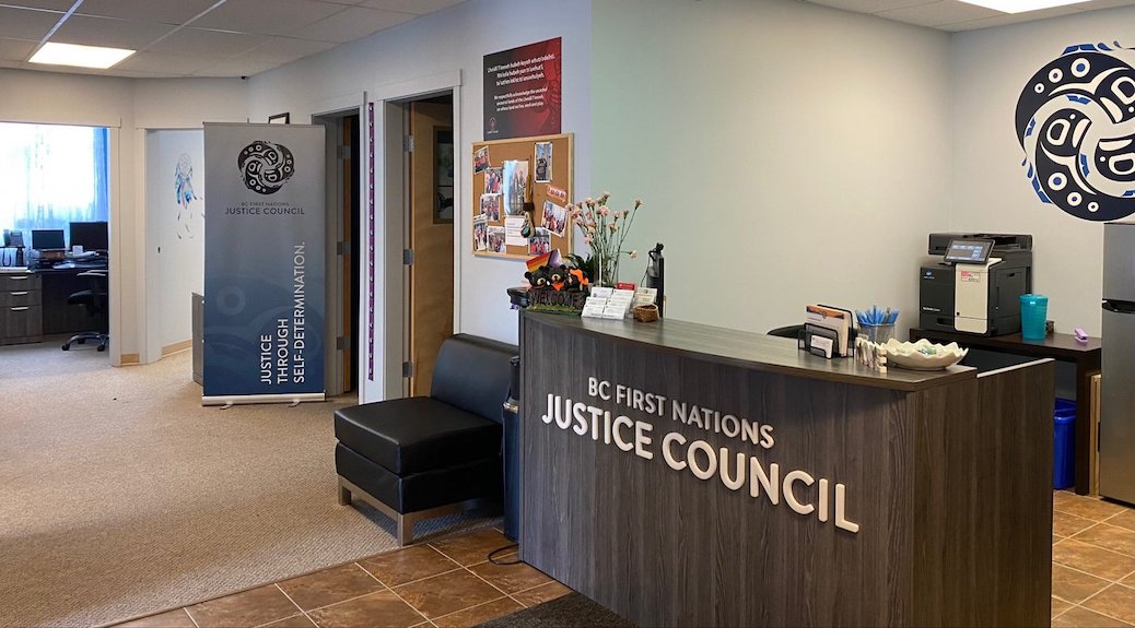 The desk inside a room has the letters BC First Nations Justice Council written on it