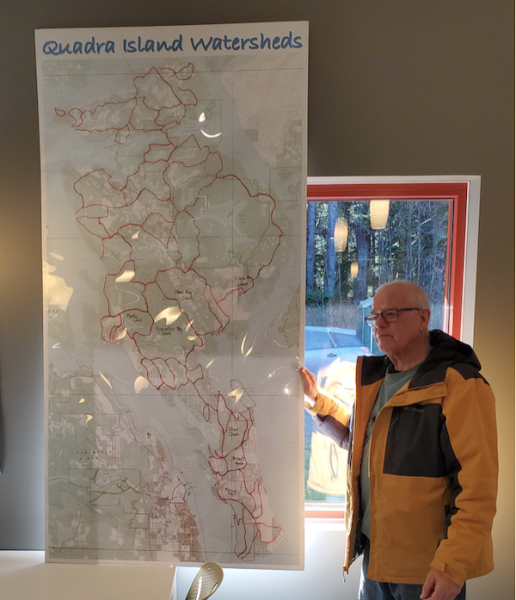 OLder man standing in front of a map