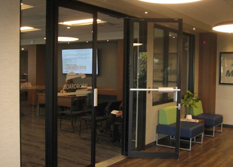 Looking through a set of glass doors with the words SRD Boardroom on them