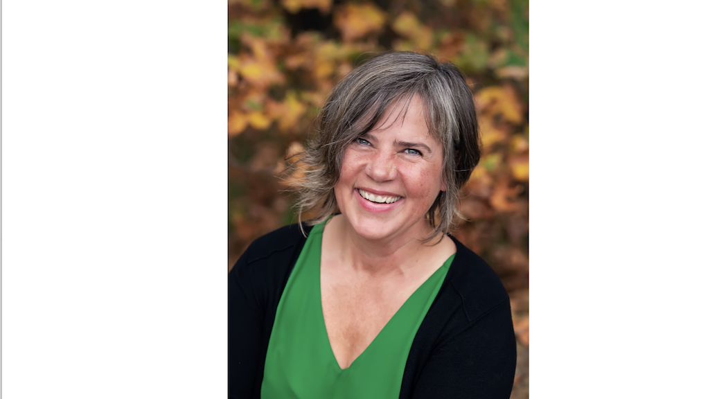 Smiloing woman in green blouse