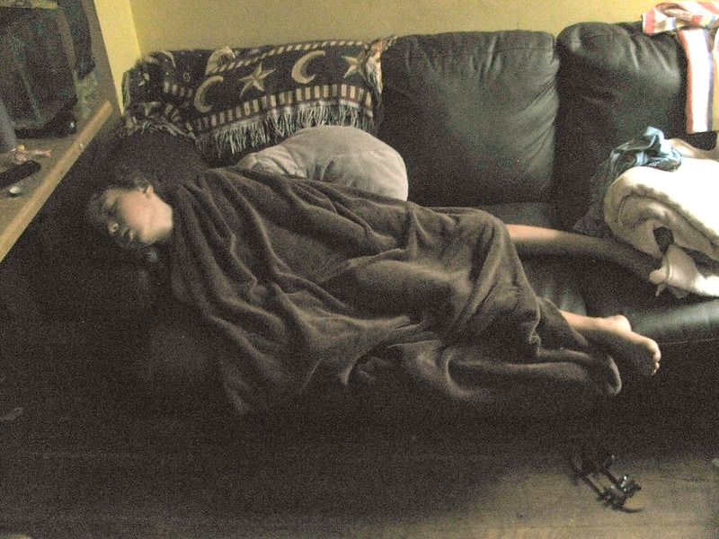 Young woman fast asleep on a couch