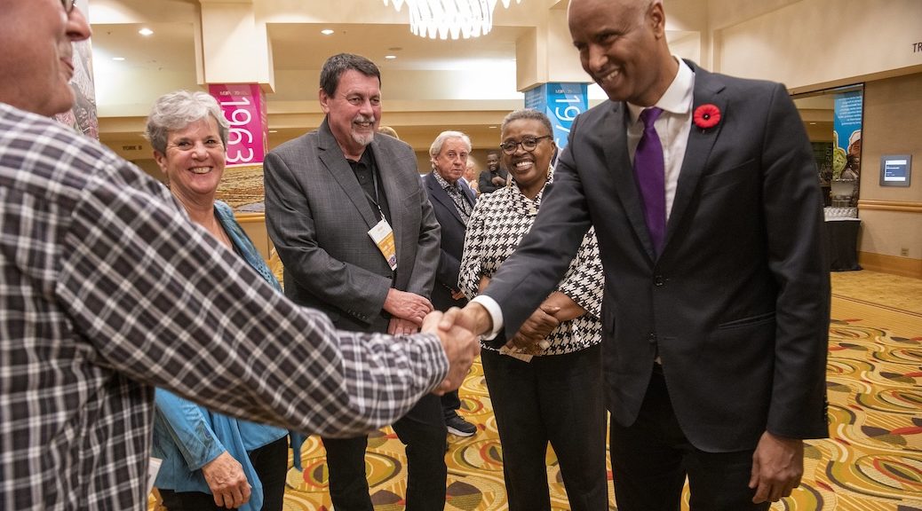 Lobbyist shaking someone's hand during convention