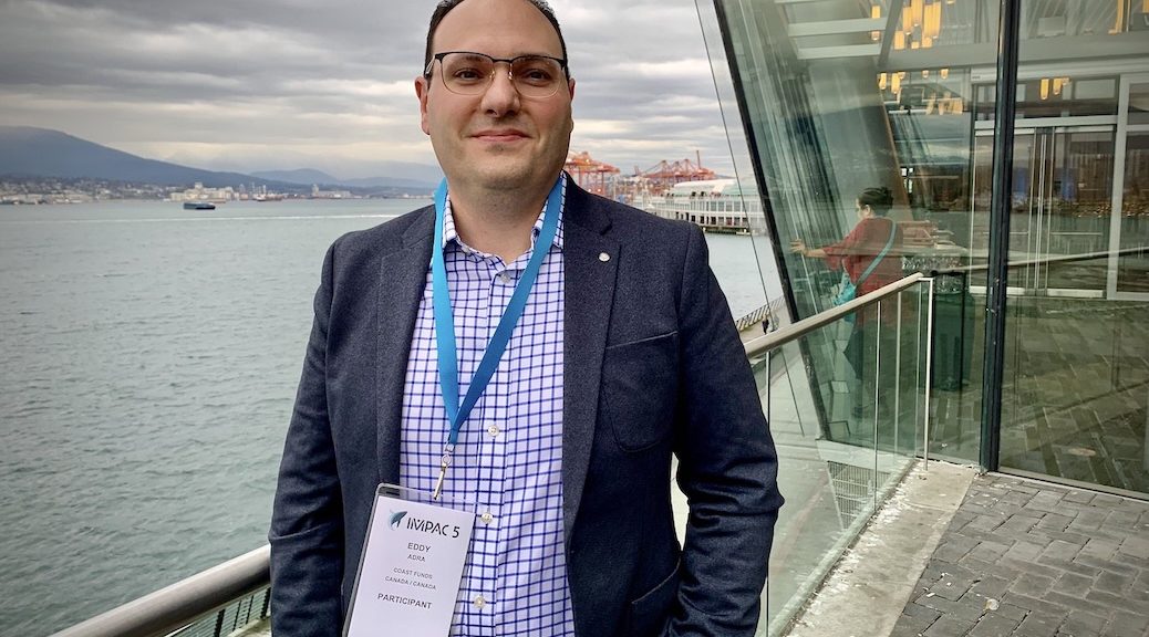 INdigenous man standing in front of waterfront