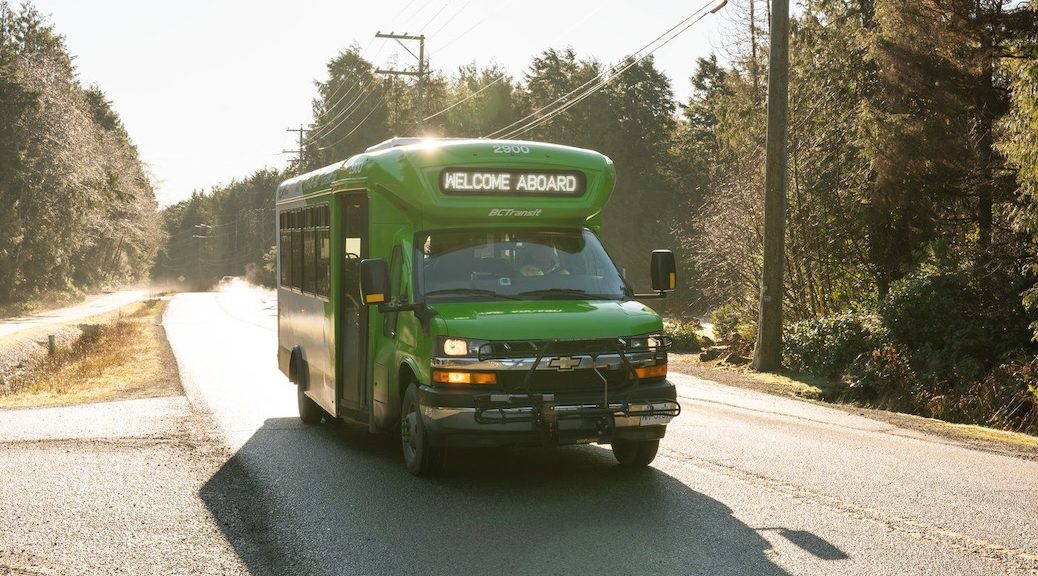 grfeen bus driving on country road