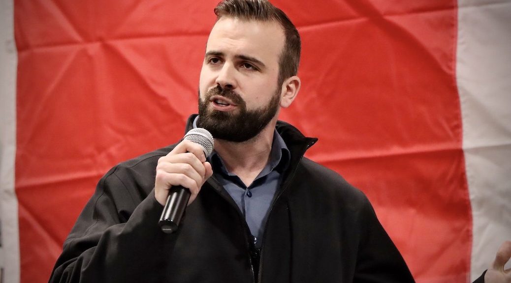 Aaron Gynn speaking into a microphone