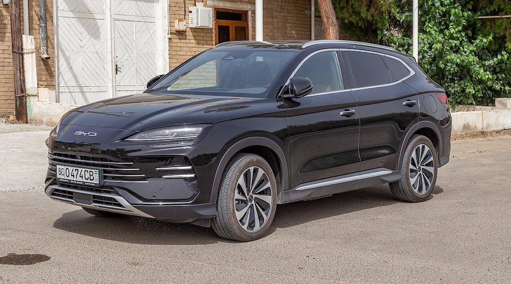 A BYD Song Plus EV parked beside a building