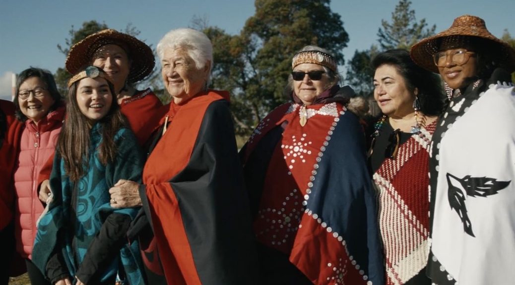 A group of Indigenous women in ceremonial dress