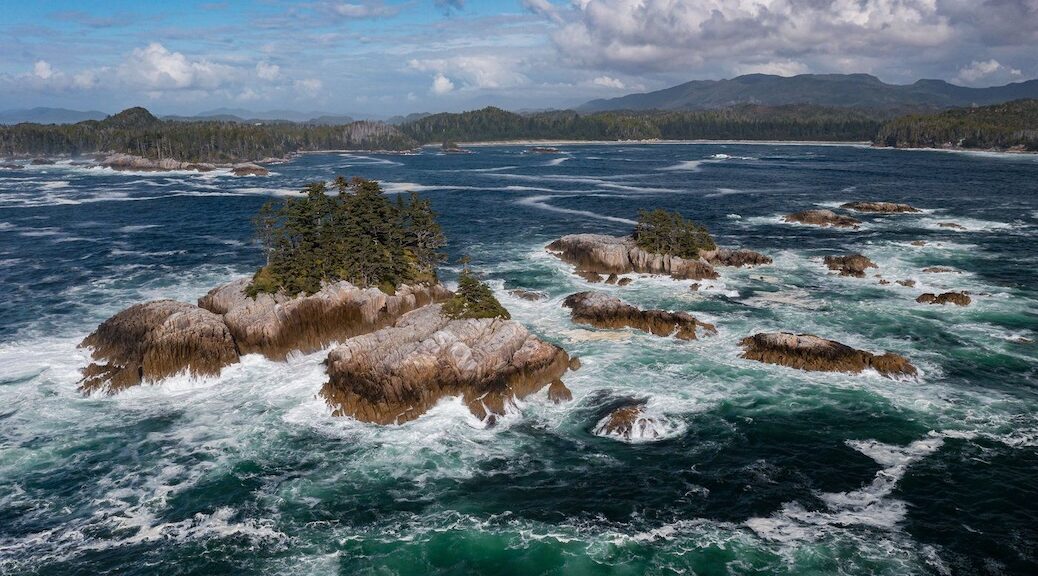 Looking from some small oislets to the rock and wooded Calvert Island