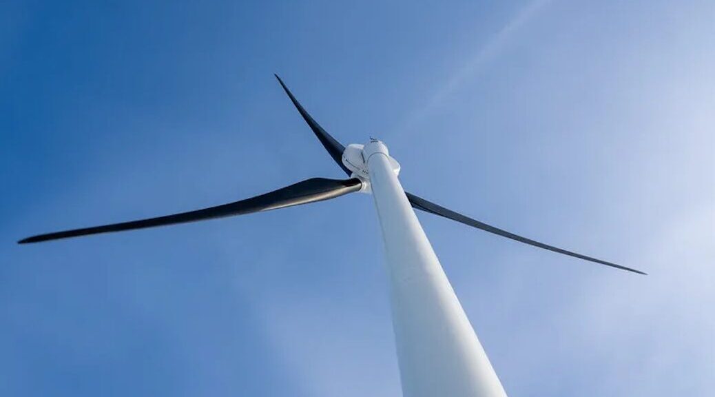 Looking up at a wind turbine