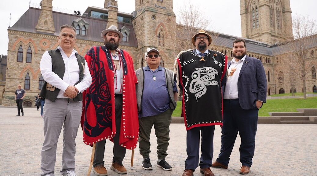 Five First Nations Leaders stand in front of the HOuse of Commons in Ottawa