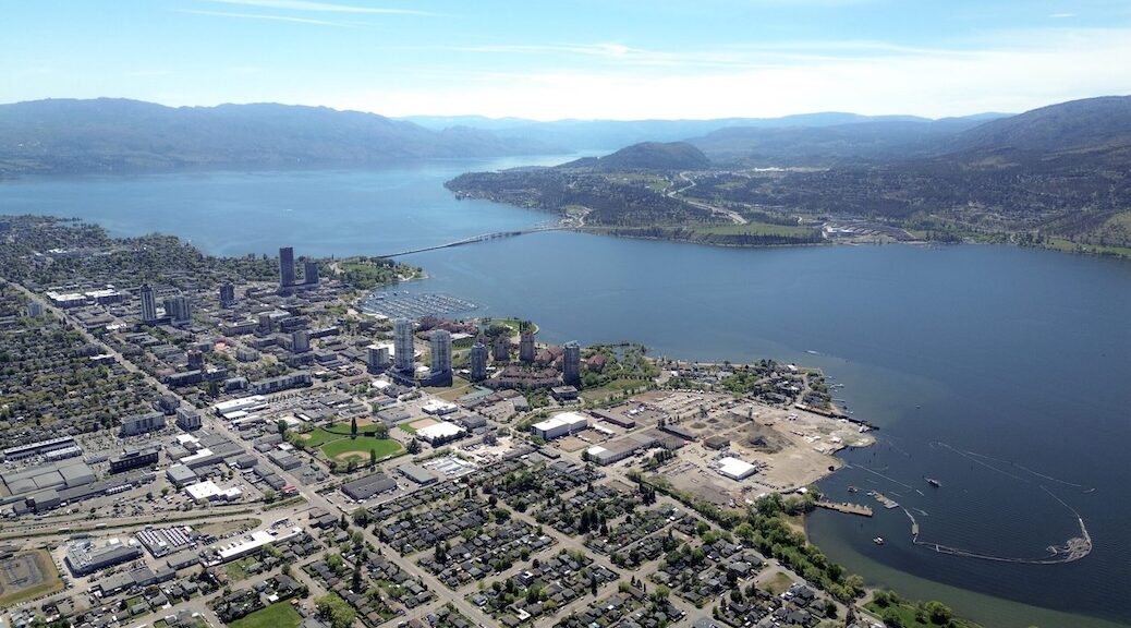 Aerial view of a city divided by water, and the bridge that joins the two halves