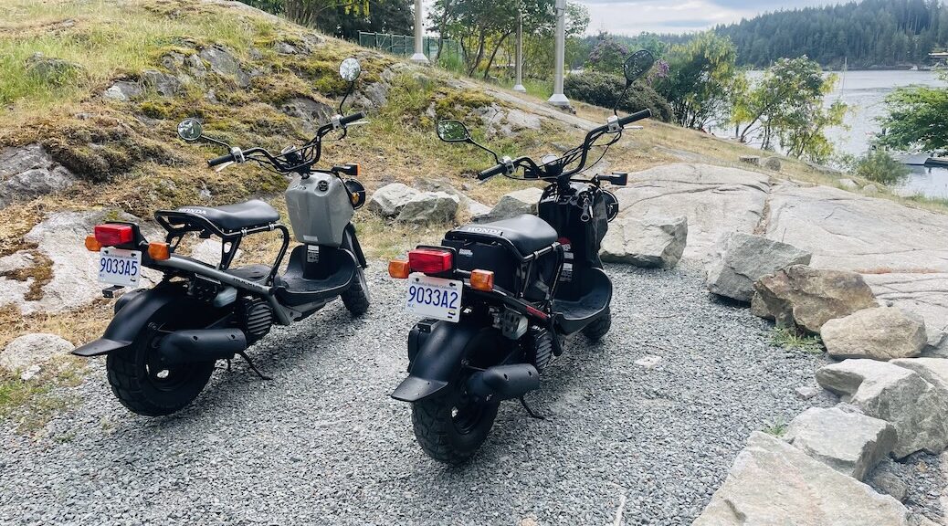 Two mopeds belong to Cortes Cruiser overlooking Gorge Harbour