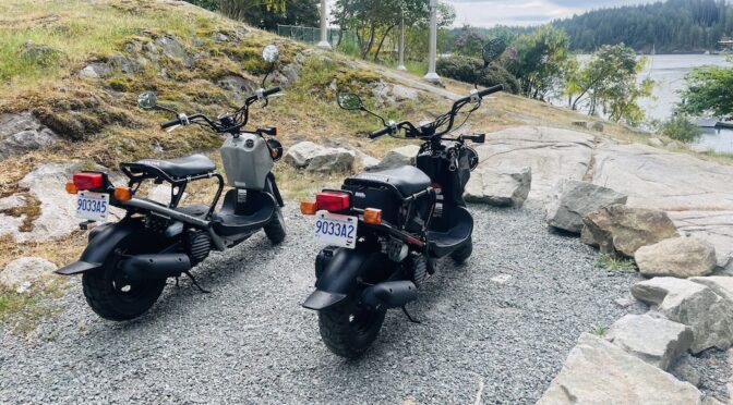 Two mopeds belong to Cortes Cruiser overlooking Gorge Harbour