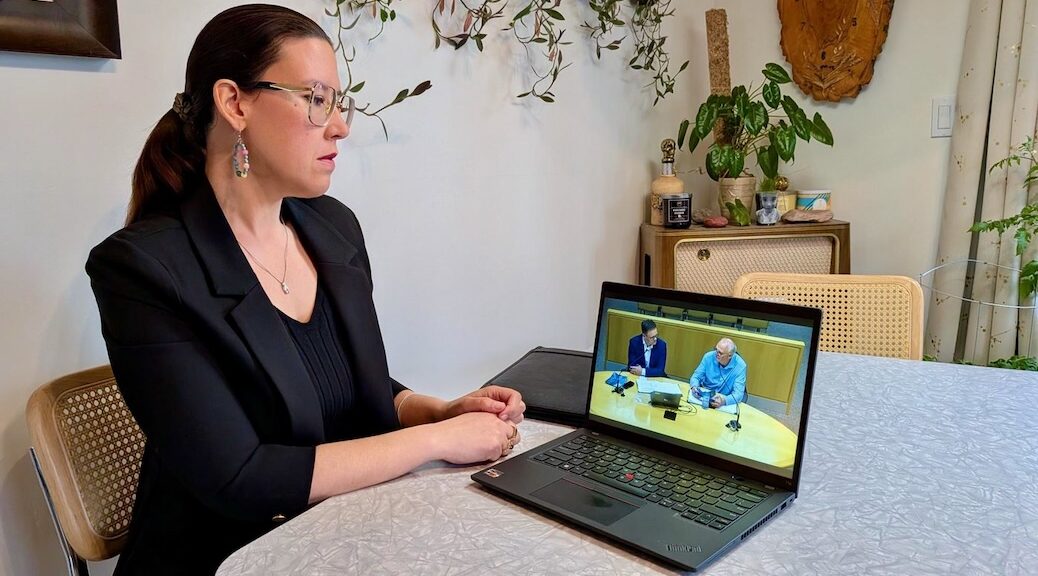 Woman watching political broadcast on her computer