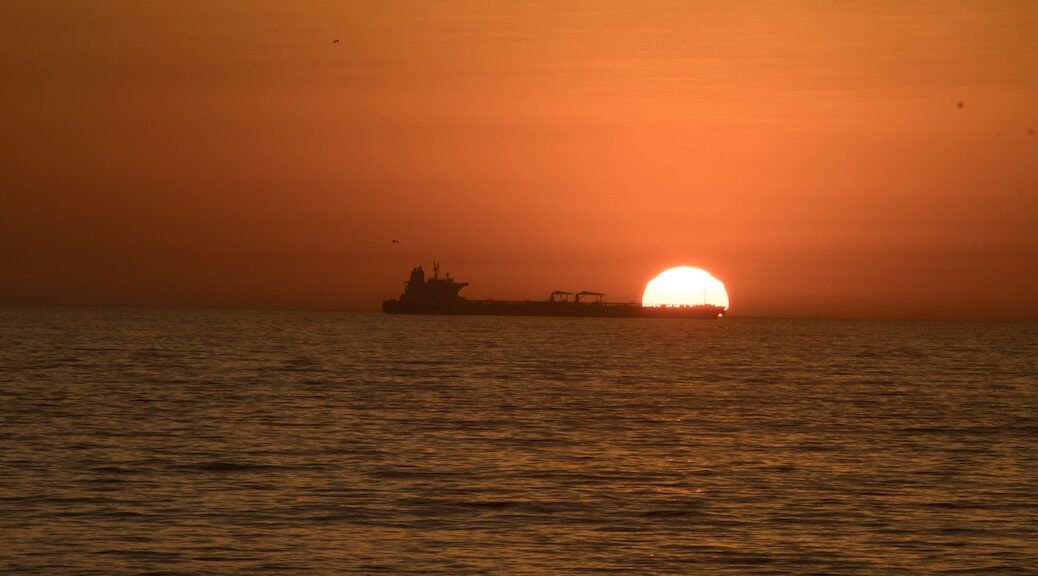 OIl tanker seen at sunset