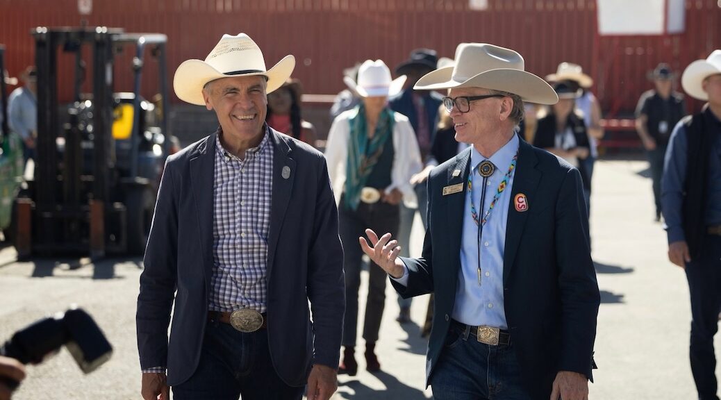 Priminister Mark Carney in a Cowboy hat in a crowd of people weareing cowboy hats